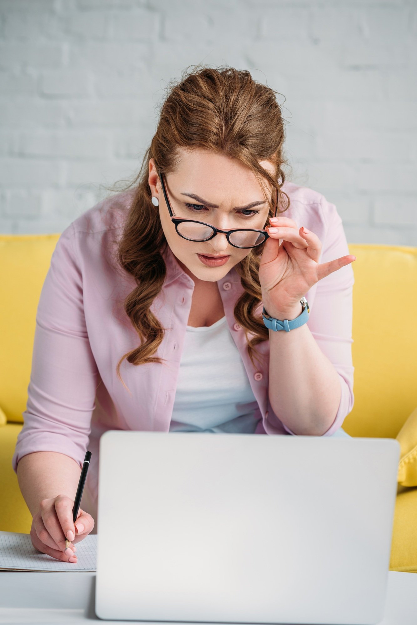 confused woman looking at laptop at home